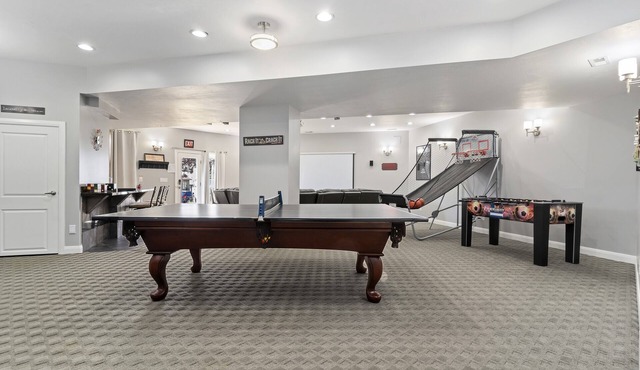 The Rec Room is a basement apartment with game tables, theater, hot tub & more!
