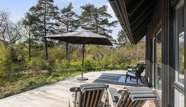 This attractive wooden house welcomes you in a wooded residential area of Tisvildeleje.