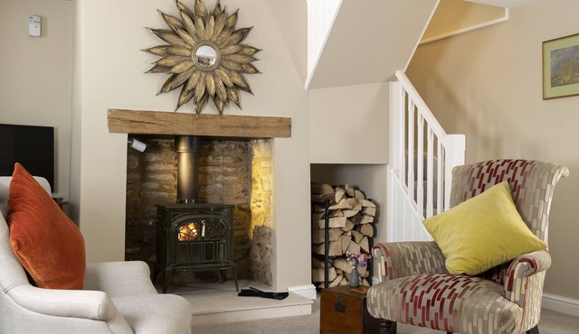 This charming Cotswold stone cottage, elegantly furnished with a seamless blend of antique and conte
