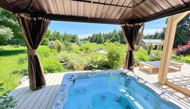 This cozy cottage offers a private hot tub, breathtaking forest views, and ultimate tranquillity