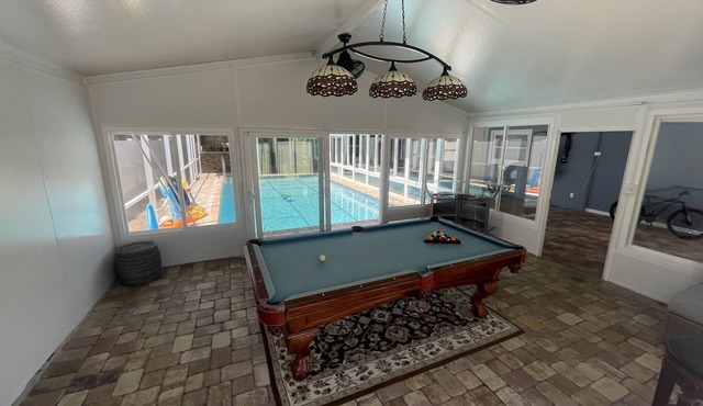 This house has swimming pool with water heater and parking for many cars.