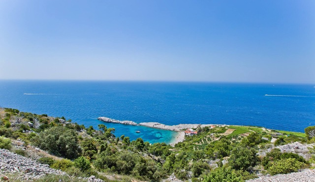 This is a house, with a large and astonishing view at the beach and open sea.