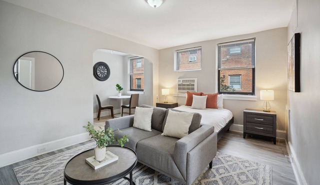 This is a studio apartment with a separate kitchen nook, and a small living nook with a loveseat