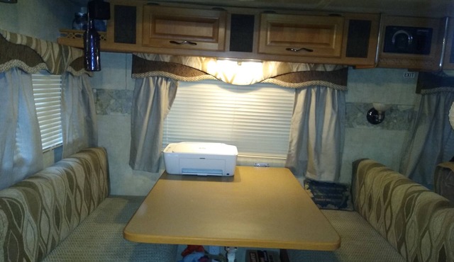 this is a very spacious RV that sits under 2 large trees
