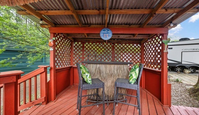 THIS IS AN AWESOME 36' RENTAL CAMPER WITH AMAZING LONG DECK, PLUS A SECOND STEP-DOWN DECK TO YOUR OWN PRIVATE HIDEAWAY TIKI BAR! A BEAUTIFUL HUGE LIVE OAK COVERS THE ENTIRE LOT SO IT'S ALWAYS SHADED, AND THIS EVEN COMES WITH A TABLE & CHAIRS FOR OUT