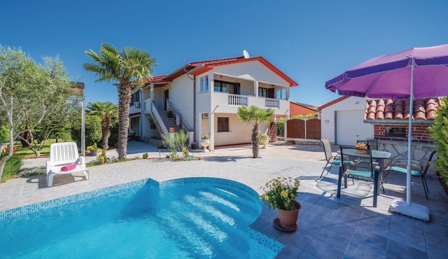 This Mediterranean vacation home with pool and beautifully landscaped garden is located in a settlem