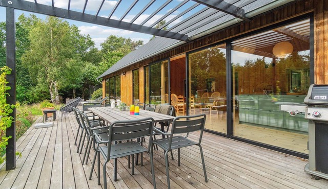 This modern and stylish wooden house welcomes you with round pool in the garden.