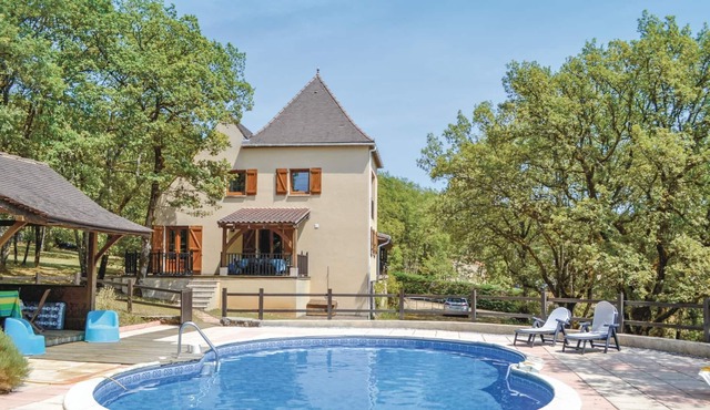 This modern house in traditional architectural style stands on an extensive, tree-filled plot surrou