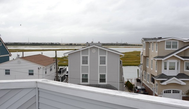This multi-level townhome offers a unique layout and panoramic bay views from a rarely available rooftop deck.