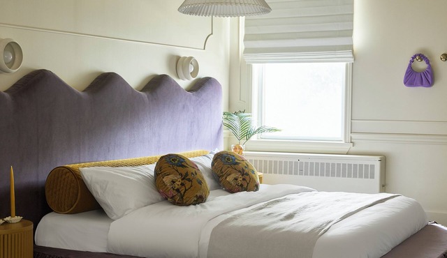 This neutral flat packs a punch with a unique and interesting feature—a round king size bed!
