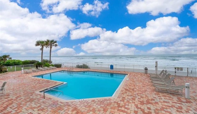 This stunning oceanfront 2BR condo in peaceful Ponce Inlet offers breathtaking beach views. Relax on the wraparound balcony with your morning coffee as pelicans glide by and dolphins surface in the waves below.