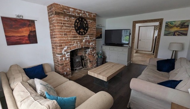 Three bedroom 16th Century terraced house yards from the sea with sea views