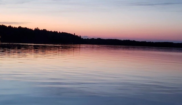 Three bedroom hide-a-way with spacious deck over looking Island Lake.