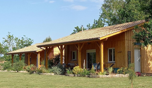 Three wooden houses with terraces near the ocean