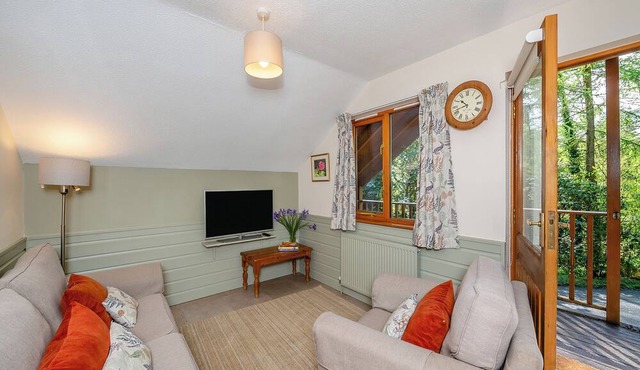 Timber lodge set high in an elevated secluded position with a view of the lake.