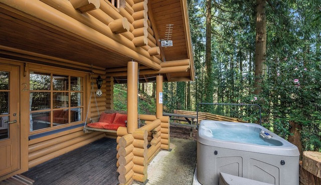 Timber lodge set in an elevated position with views of the lake.