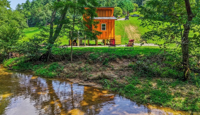 Tiny cabin sits by a bubbling, stocked creek. Pet friendly for a fee, hot tub