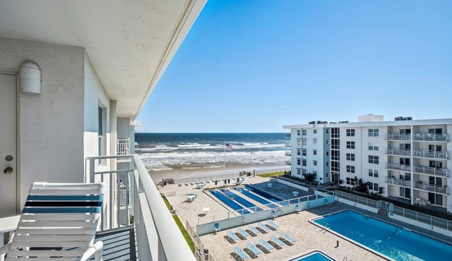 Top-floor 2/2 condo with ocean/pool views, private balcony, and heated beachfront pool
