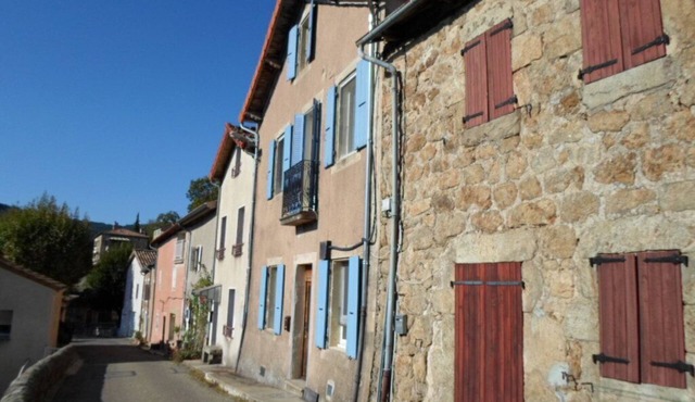 Traditional blue-shuttered stone house in a stunning Ardeche mountain village.