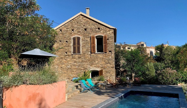 Traditional house between sea and mountain
