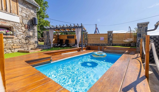 Traditional Lika home with pool and jacuzzi surrounded by nature.