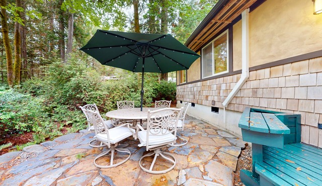 Tree-lined retreat with wood fireplace, board game collection, & pool access