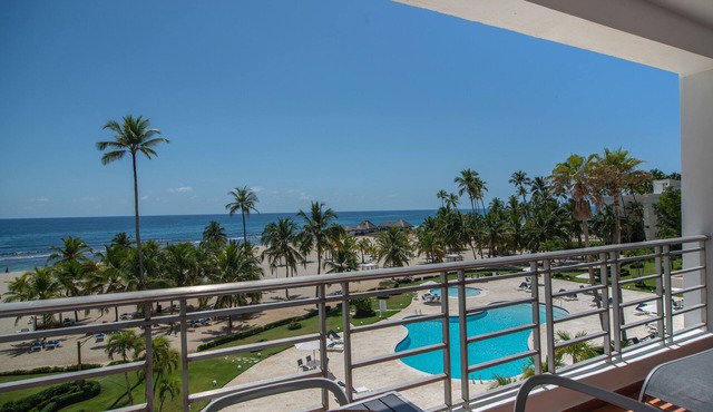 Trendy Beach Scene at a Harmony Beachfront Condo in Costa del Sol