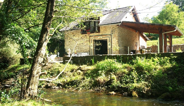 Twelfth-century mill in a green setting.