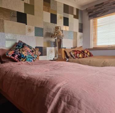 Twin beds with private bathroom at Fir Tree Lodge