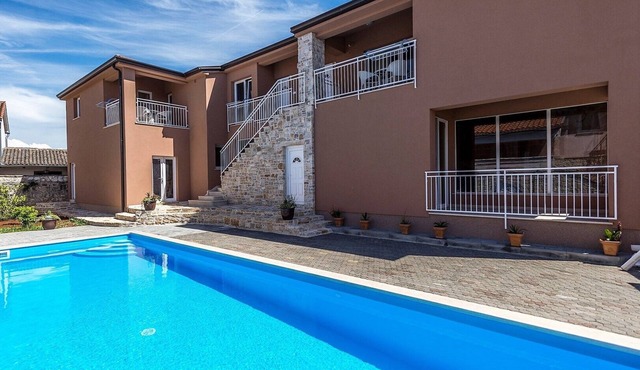 Two-Bedroom Apartment in Villa Valtrazza Noa IV with Balcony and Pool View