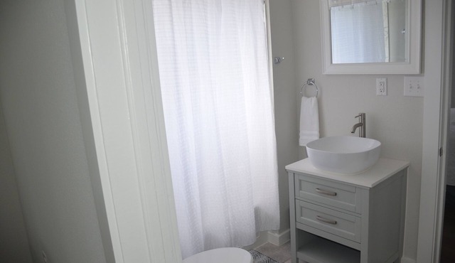 Two bedroom, one bath, modern bungalow with full kitchen and outdoor dining.