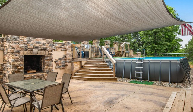 Two-story, dog-friendly home with a pool, indoor/outdoor fireplaces, & AC