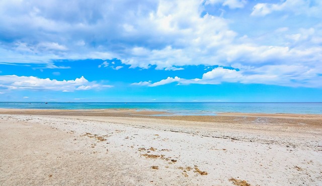 Two-story home near the beach with spacious deck, grill, modern kitchen, & W/D