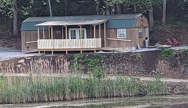 Unique cozy 14x40 Cabin with a nice deck by the water .
