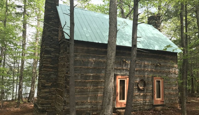 Unique Historical log cabin with private beach and 300 ft. of waterfrontage.