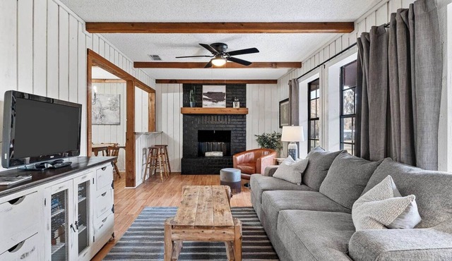 Unwind in a cozy rustic-modern cabin with a front porch, private dock access, firepit nights, outdoor dining, and cornhole. RV site next to house.