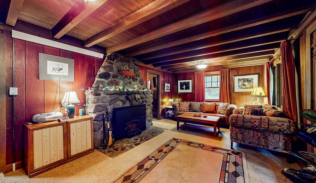 Unwind in nature's embrace at a 1925 cabin with hot tub & river views