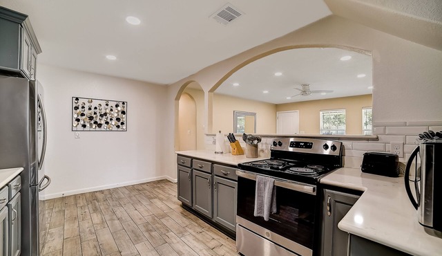 Updated, dog-friendly home with fenced yard, grill, sunroom, & W/D