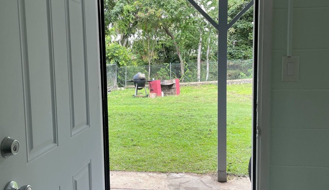 Urban Oasis in heart of lively city - large yard surrounded by trees and stream