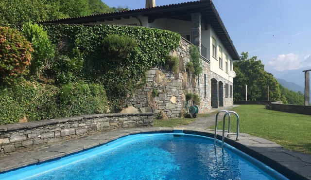 Vacation home with outdoor pool and lake view offers tranquility and privacy.