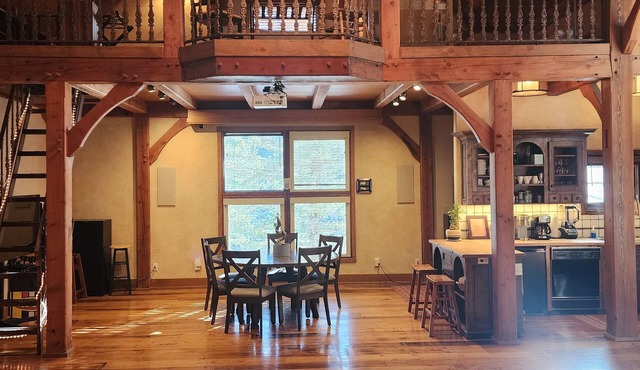 Vaulted beam ceilings, a huge rock fireplace, stream nearby, large campfire area