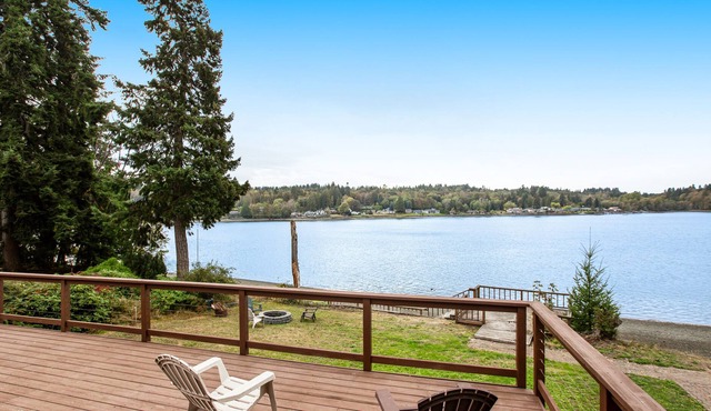 Vibrant waterfront home with large deck, woodstove & striking sunset views
