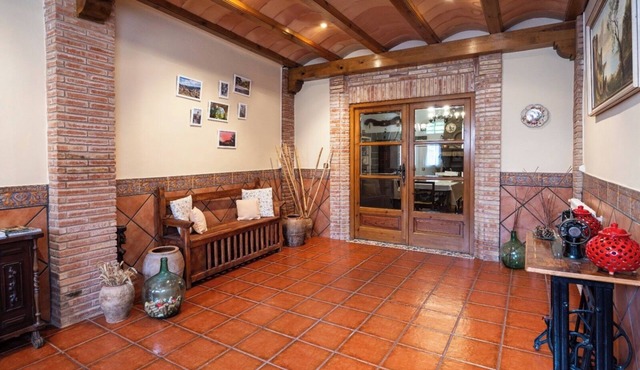 Village house with picnic area and fireplace.
