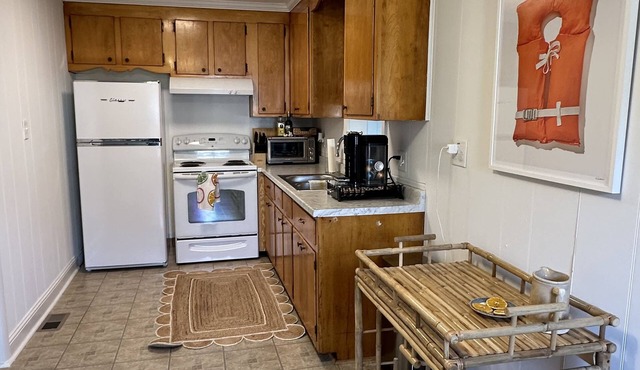 Walk to town from this cozy Rivah house with awesome yard and water views.