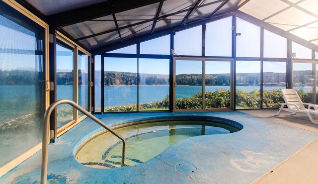 Water-view condo with deck, grill, yard games, resort pools, hot tub, and gym