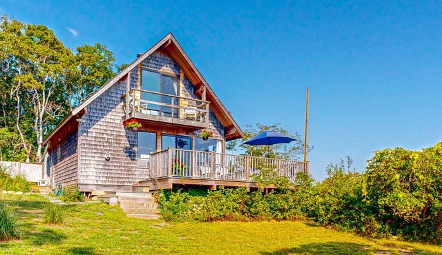 Water-view home with large deck, balcony, enclosed sunroom & peaceful location