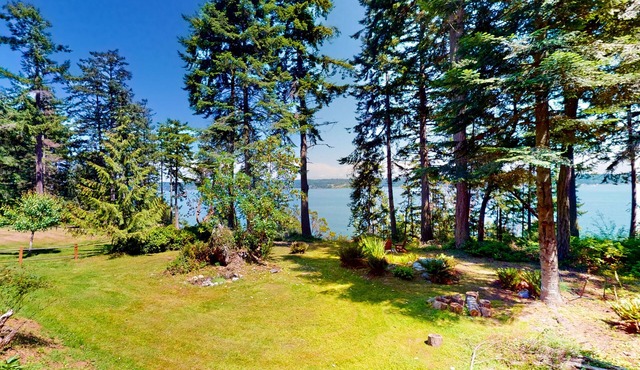 Water-view home with large deck, firepit, grill, & W/D