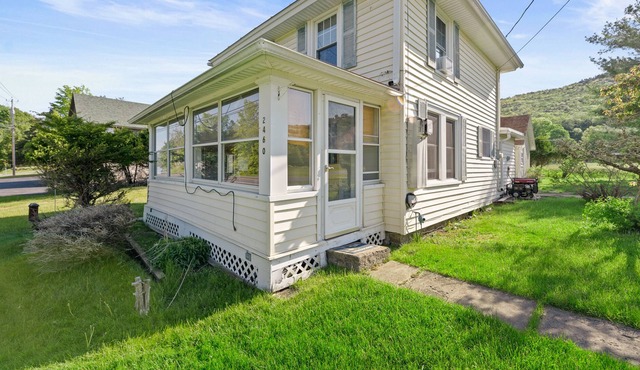 Water view home with a wood stove, grill, & partial air-conditioning - dogs ok