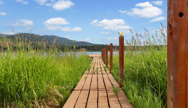 Waterfront family home with large yard, firepit, deck, river views & boat slip