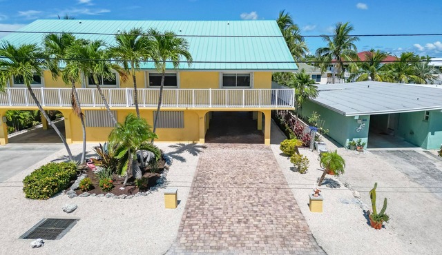 Waterfront home with dock, filet station, patio, balcony, & Cabana Club access